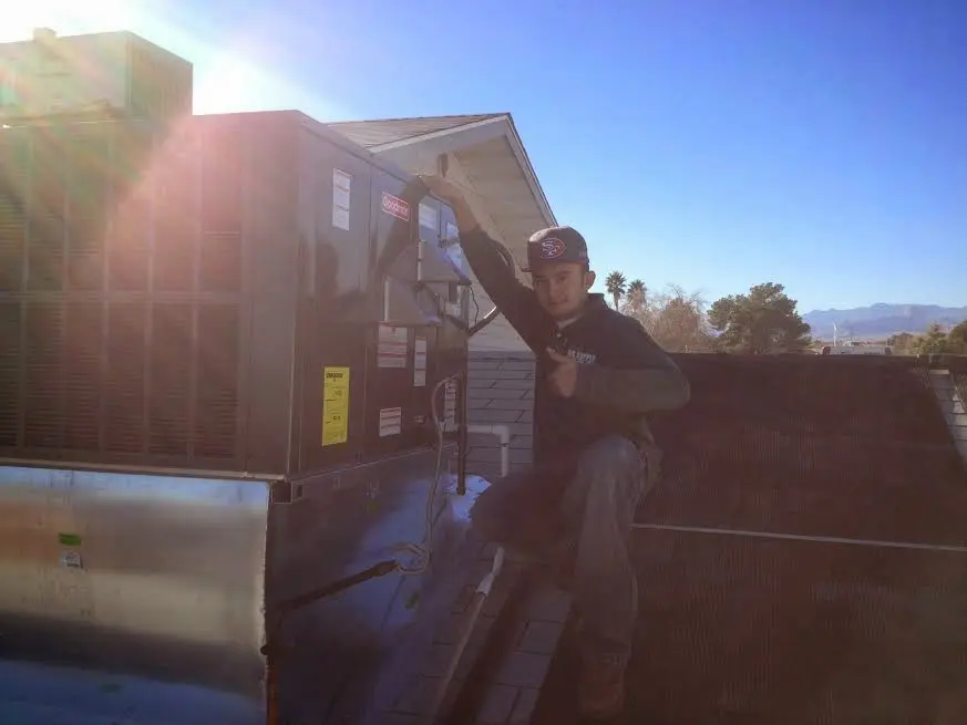 HVAC technician performing HVAC Inspection on a rooftop unit in Wyndham
